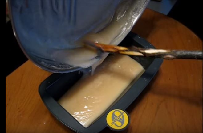 scraping soap into mold
