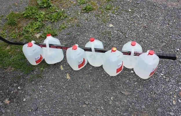 carry water gallons with stick