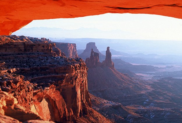 View of Canyonlands National Park from underneath Mesa Arch.