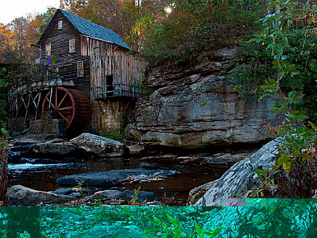 A cabin, water wheel and river in Babcock State Park, West Virginia.