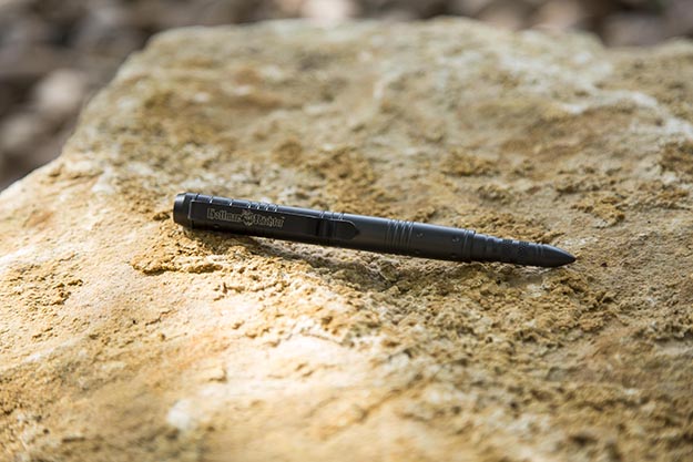 The Hoffman Richter Stinger Tactical Pen on a rock background