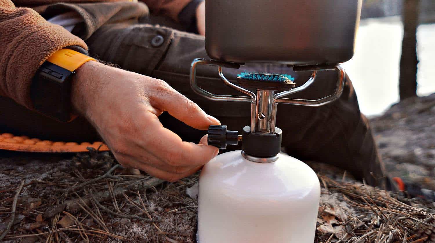 Traveler opening a propane tank for cooking | A Primer On Propane For The Practical Prepper-Part II | Featured