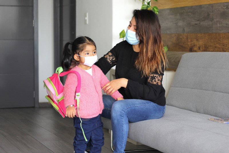 latin mom and 3 year old girl with protective face masks and backpack for back to school-Back to School Preparation