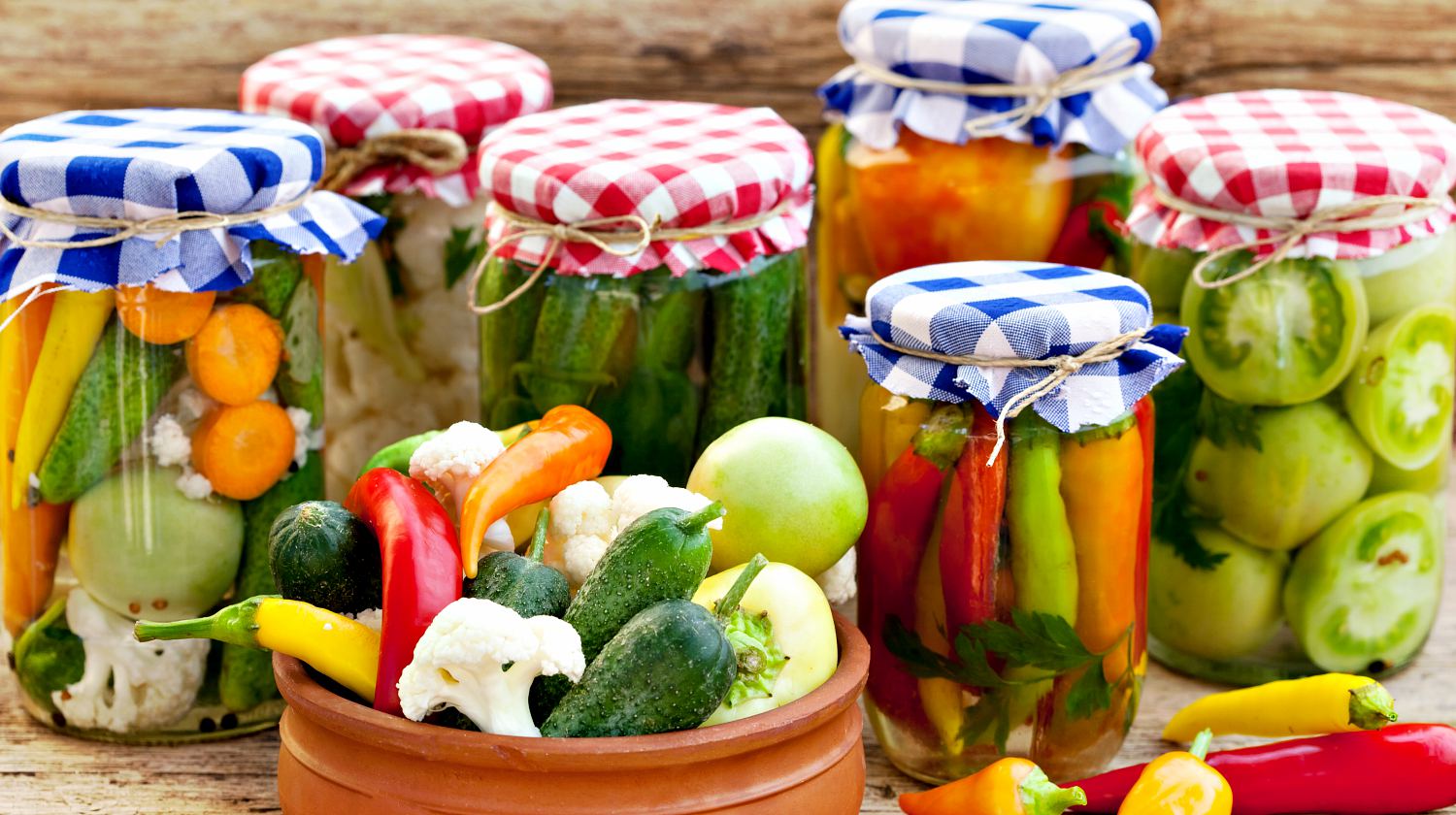Jars with pickles, green tomatoes, cayenne pepper, mixed salad and chillies | Canning Tips To Make Food Last For A Long Time | Featured