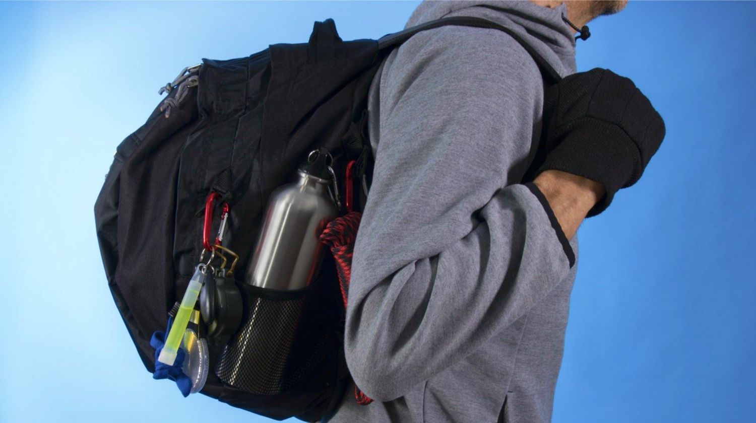 Feature | Man with bug out bag on blue background | How To Argue With Non-Preppers