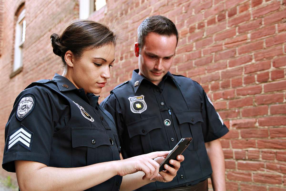 Two police officer looking in mobile phone | Home Security And Crime Prevention Secrets