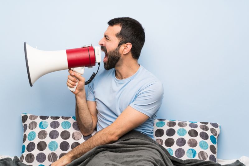 man bed shouting through megaphone | Use a Bullhorn to Scare Intruders Away | invasion survival kit 