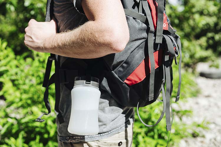 Stone Mountain AquaLight water bottle attached to a man's backpack.