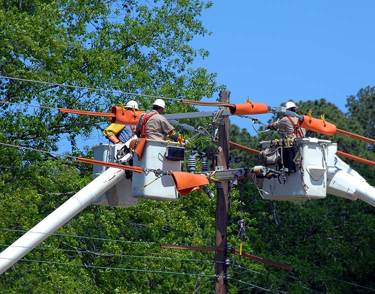 A crew of men working on a power line during a power outage.