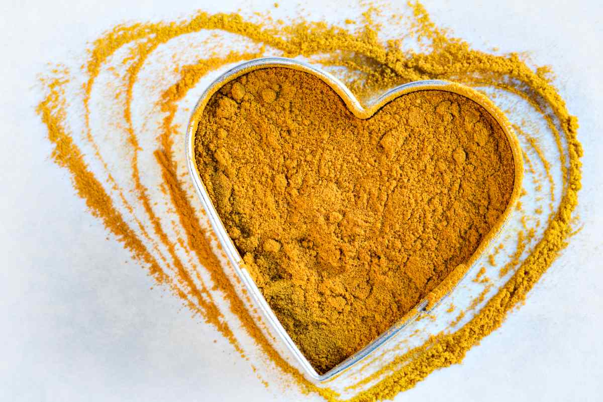 Ground turmeric in a heart shape | Turmeric Benefits: Improving Your Health And Natural Healing At Home 