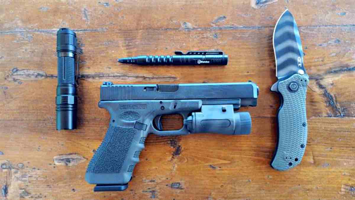Gun, knife, flashlight and pen on the table | Tactical Pens: They “Ain't” Just For Writing