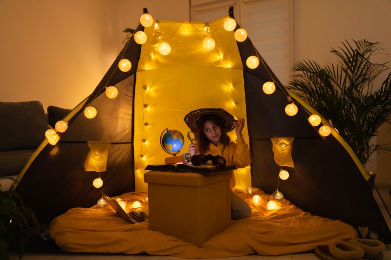 young-female-child-using-magnifying-glass camping light 