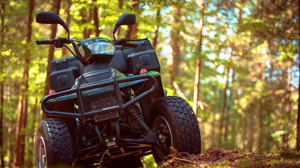 ATVs parked in the parking lot in the forest doomsday defense feature getty