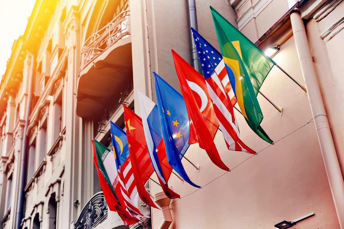 Flags of russia, united states, brazil, turkey, china, european union, iran on embassy house | Travel Safety Tips You Shouldn't Ignore