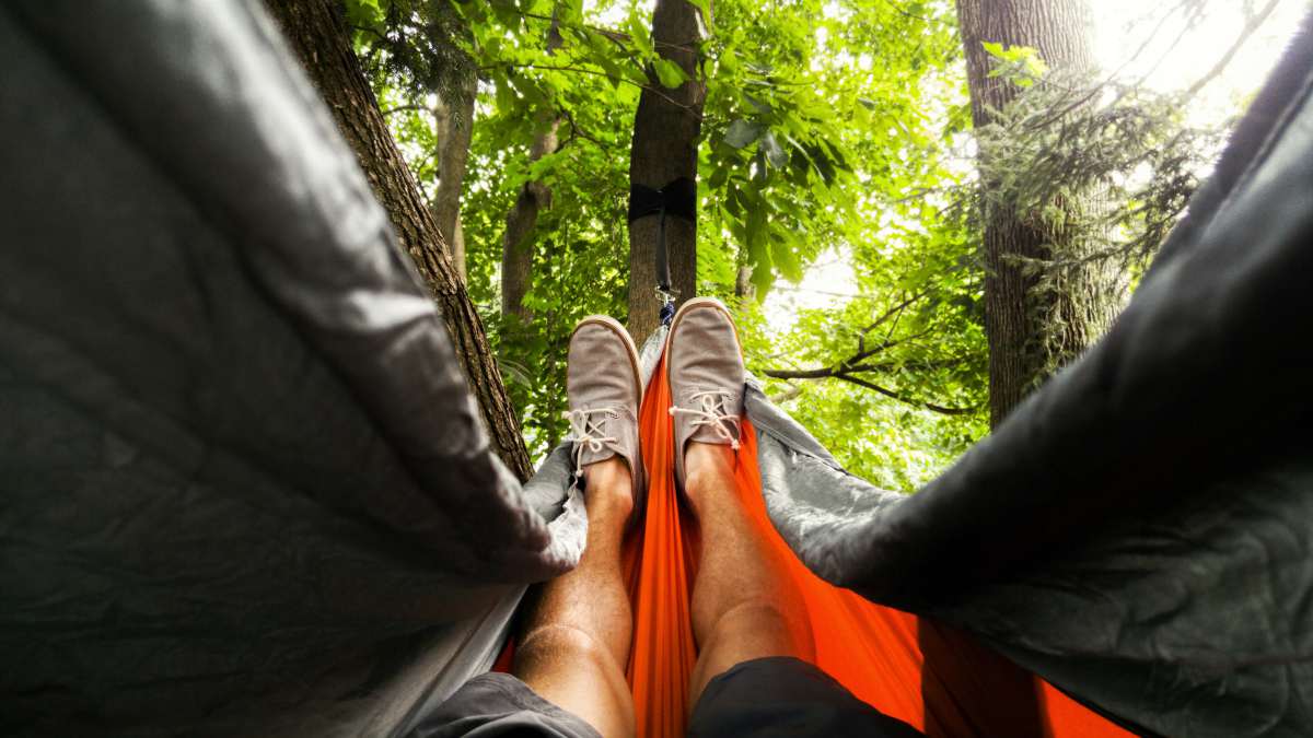 Focus image person feet sitting in the hammock | How To Make A Hammock In The Rainforest And Elsewhere