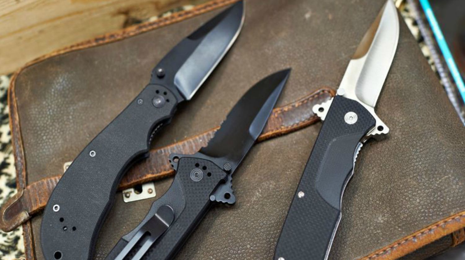 Feature | Three folding knives on top of leather bag | Eye-Catching Folding Hunting Knives