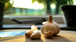 photography of garlic on wooden table home remedies feature px