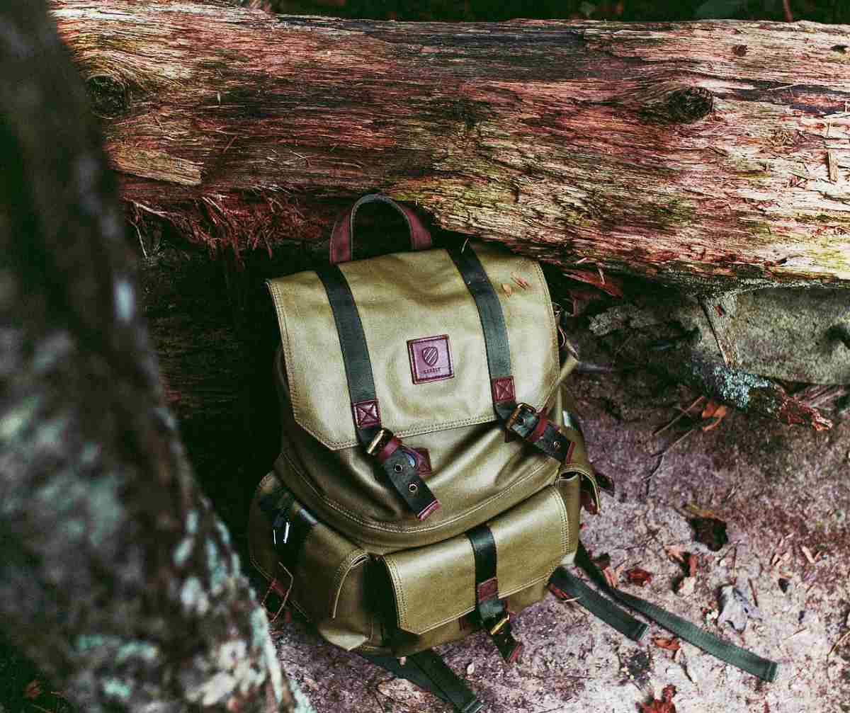 Green bag in the woods | The Ultimate Bug Out Bag List For Every Survivalist