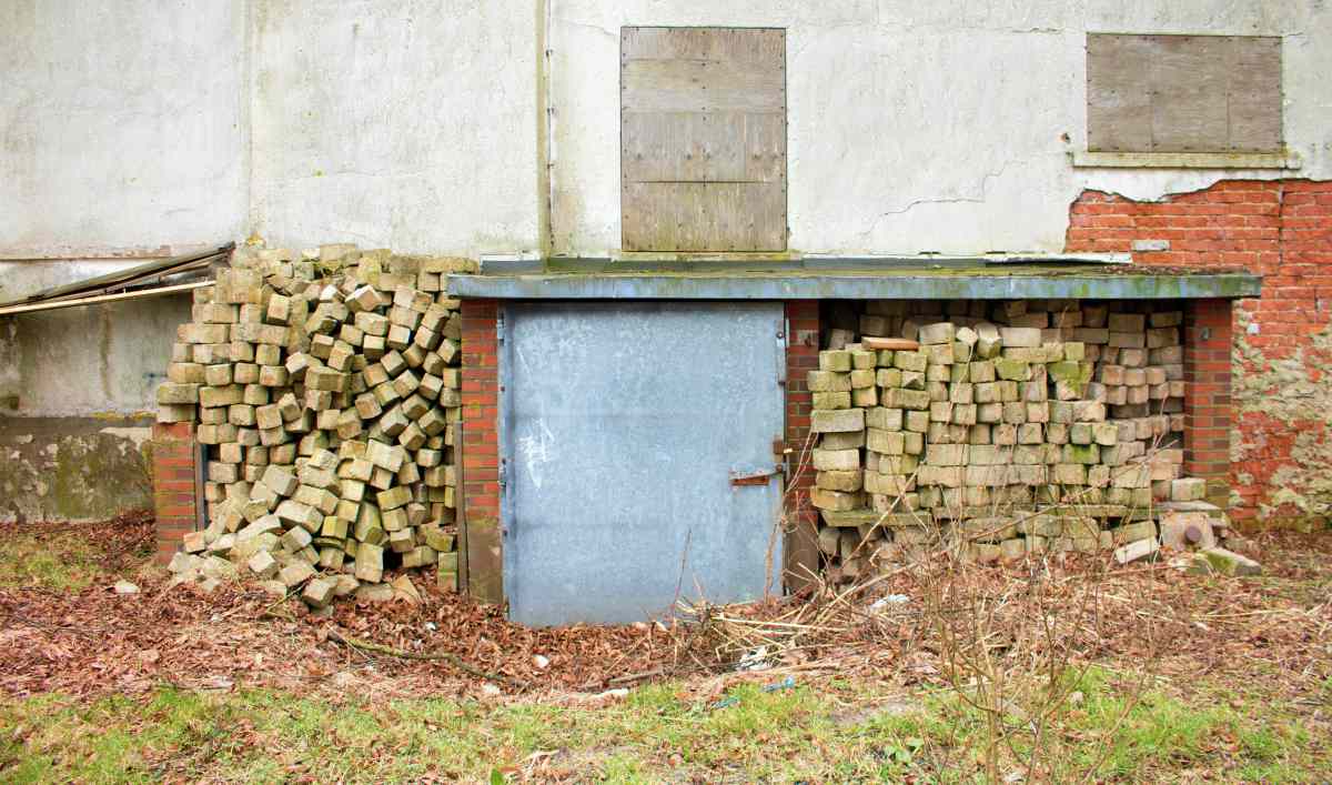Rusty metal cellar door in garden backyard for security | How To Build Your Own Underground Bunker For Survival