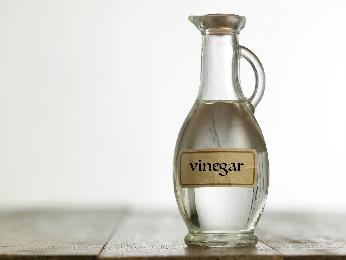 White vinegar on the wooden table | Survival Food Items That Will Outlast The Apocalypse