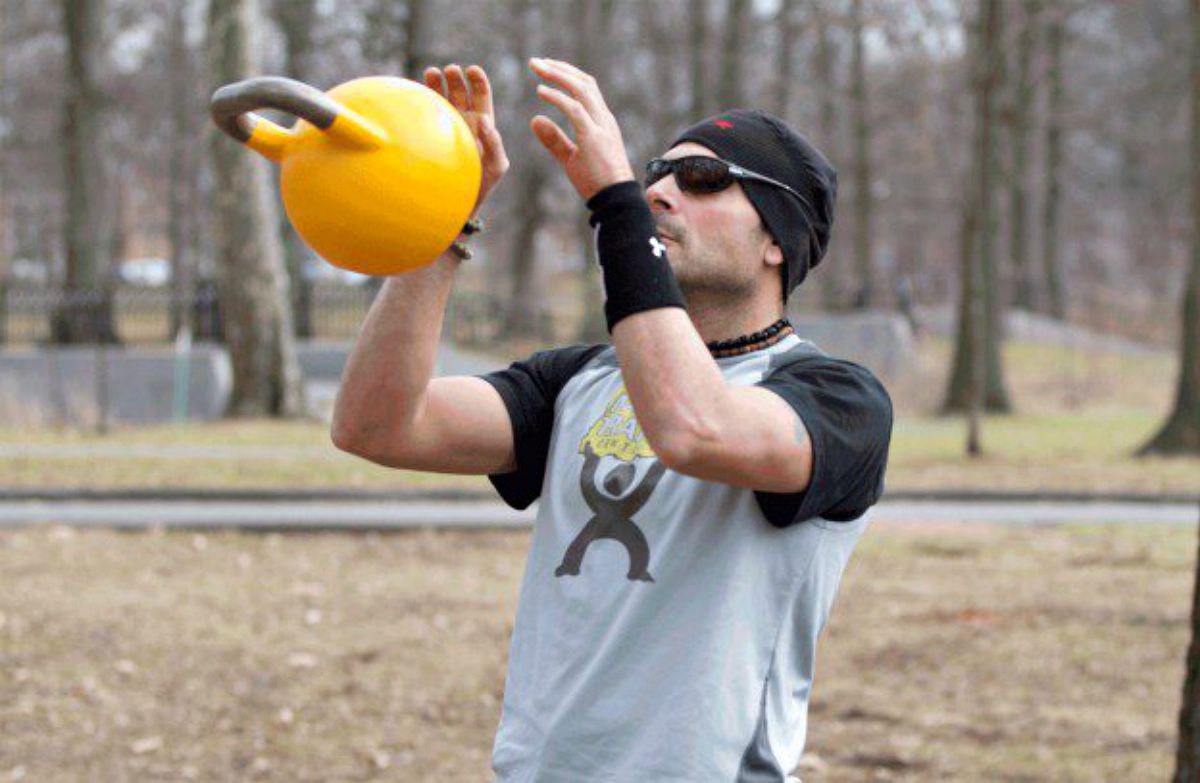 Man with yellow kettlebell in the park | Why The Kettlebell Is The Ultimate Tool For Physical Preparedness