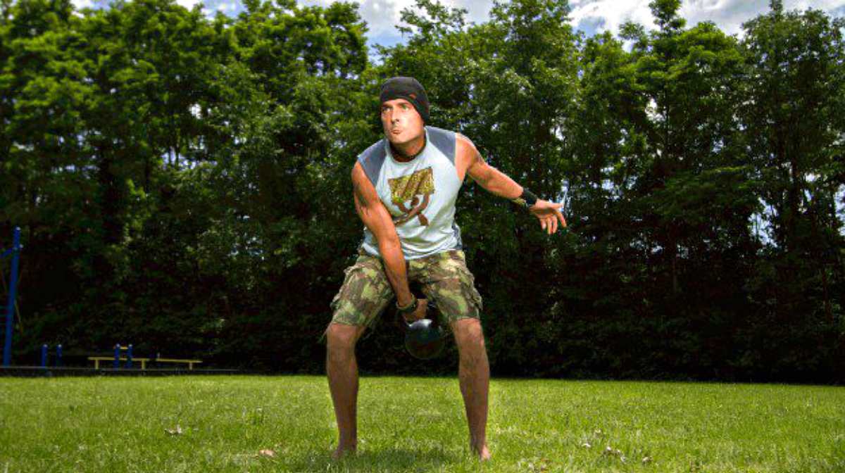 Man in the park holding kettlebell | Why The Kettlebell Is The Ultimate Tool For Physical Preparedness 