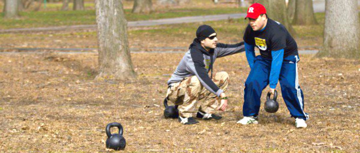 Man practice kettlebell with his trainer | Why The Kettlebell Is The Ultimate Tool For Physical Preparedness