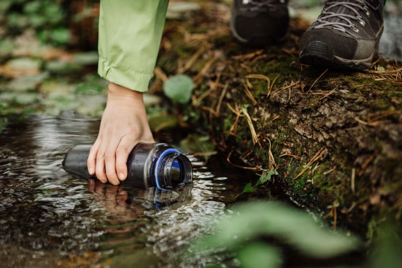 beautiful-woman-taking-water-forest-spring survival hacks 