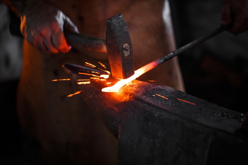 blacksmith-manually-forging-molten-metal-on survival hacks 