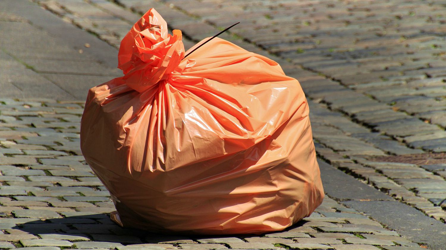 Feature | Orange garbage bag in the street | Uses For Trash Bags | Bug Out Bag Essentials
