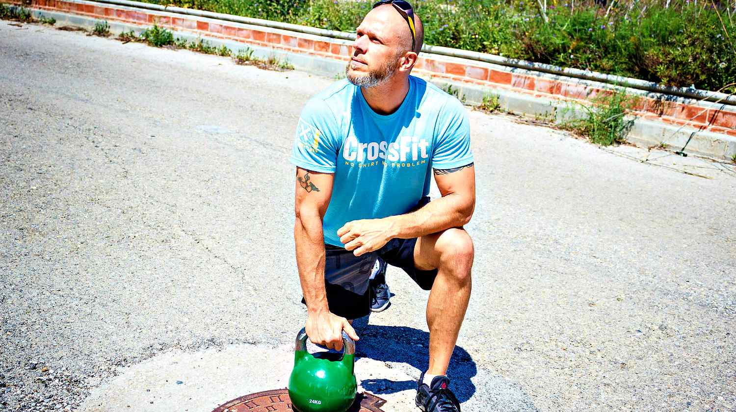 Feature | Man wearing crossfit shirt holding his kettlebell | Why The Kettlebell Is The Ultimate Tool For Physical Preparedness
