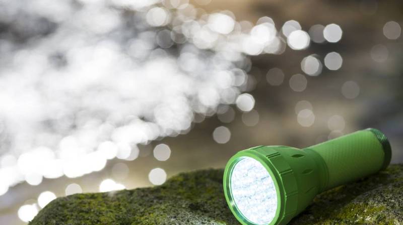 led flashlight on mossy rock glitter Dollar Tree prepper items 