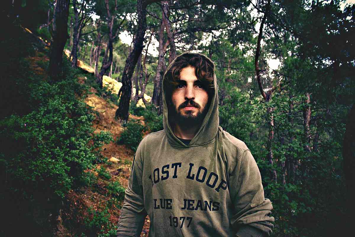 Man wearing hoodie lost in the forest | Steps To Survive Anything