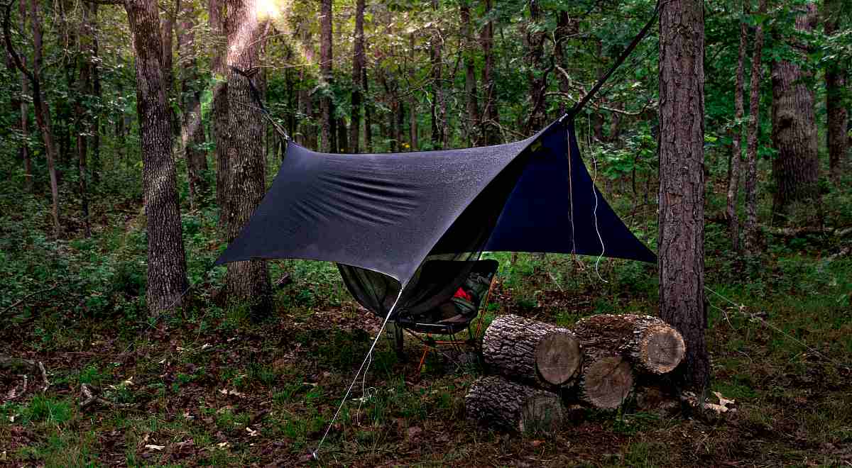 Camping hammock with rain cover at sunrise | How Camping In The Rain Can Prepare You For A Disaster