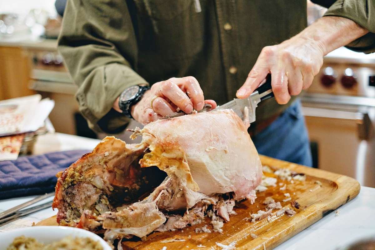 Father carving the turkey for diner | How To Carve A Turkey Like A Pro: Holiday Tutorial 