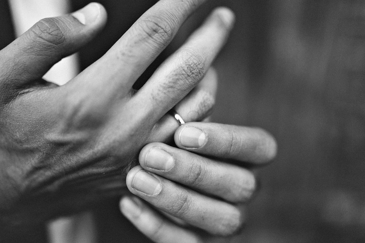 Black and white photo of hands wearing ring | Ring Stuck On Finger? This Trick Could Save Your Finger And Your Ring