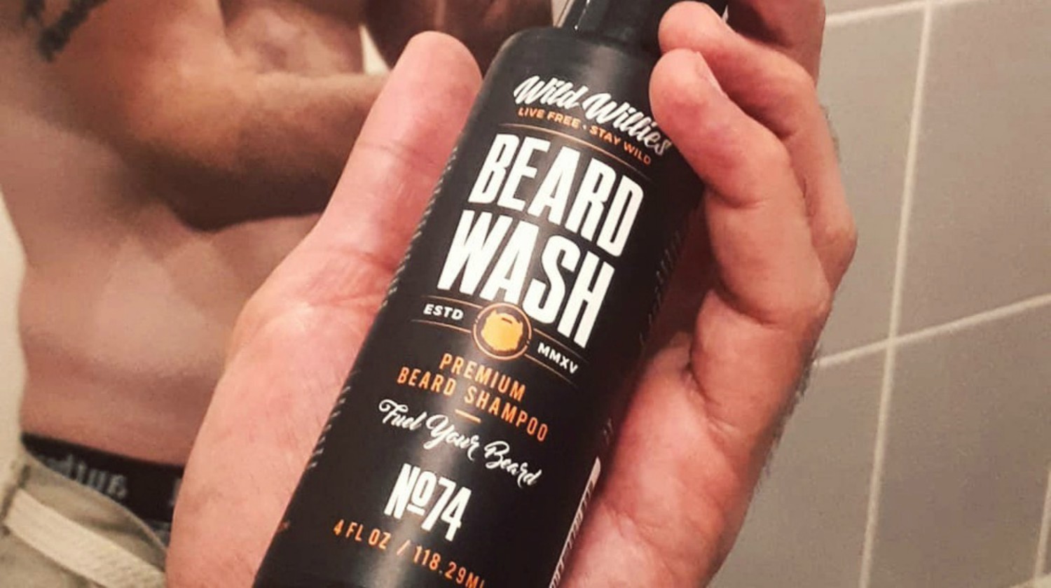 Feature | male holding Wild Willies beard shampoo beard wash | Top Beard Wash Ingredients And What They Do