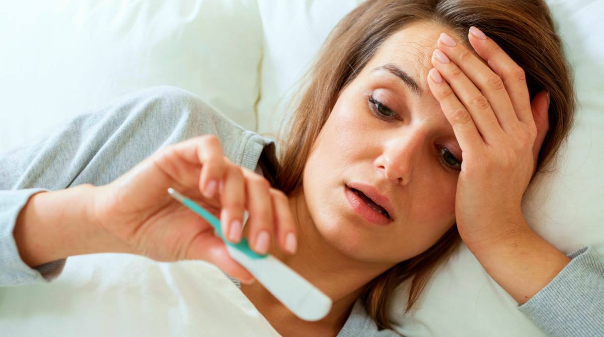 View of woman with fever in bed | Survival Uses For Peppermint Oil