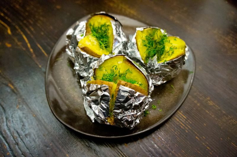 grilled-potatoes-foil-served-on-dark | camping food