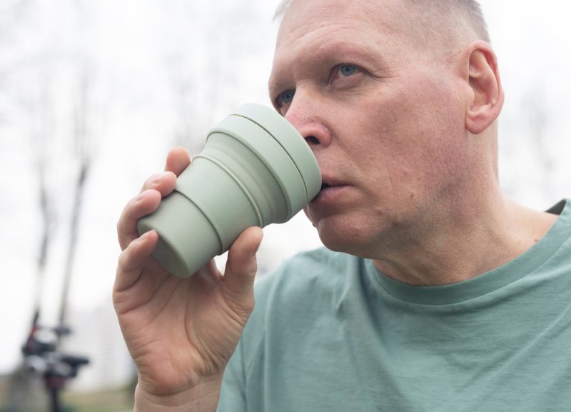 mature-man-holding-eco-reusable-cup | Camping Hacks