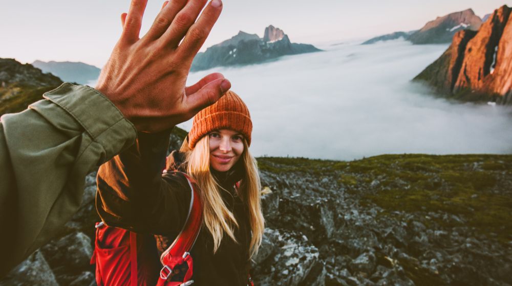 travel couple friends giving five hands Couples Defense | Featured Image