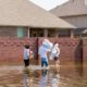Featured Image | residents-walk-high-waters-after-devastating | flood survival tips