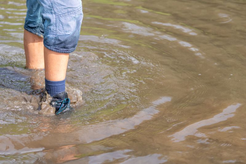 young-boy-blue-shorts-wet-socks flood survival tips