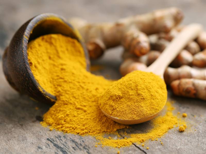 Turmeric-powder-fresh-on-wood-background How to get rid of spiders