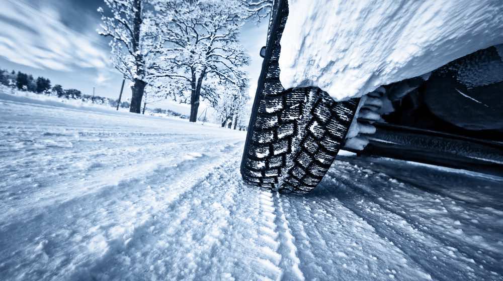 Car tires on winter road | winter driving tips
