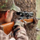 guy holding a rifle | Deer Hunting For Beginners: How To Get Started