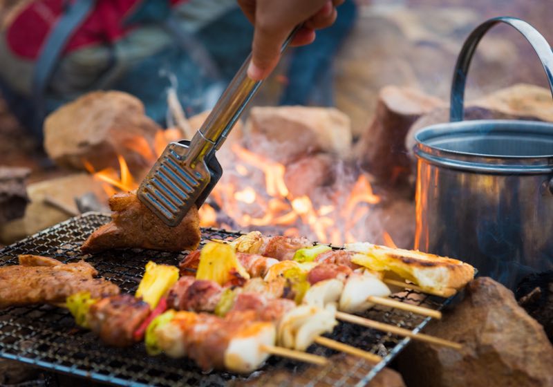 Close up grilling barbecue in the campground at summer camp travel, Skewers of pork and beef fillet on barbecue party in camping, Summer Camp Travel one activity for relaxing. | Campfire Cooking