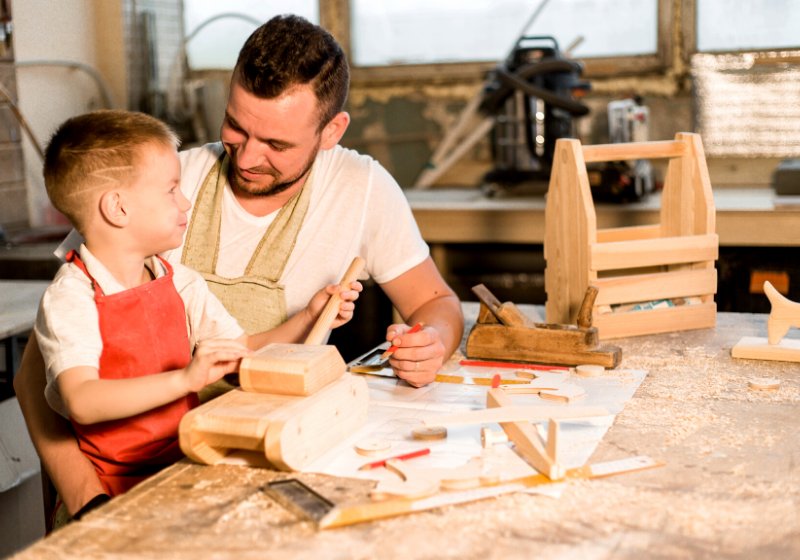 dad son carpenters shop make wooden | new year health tips