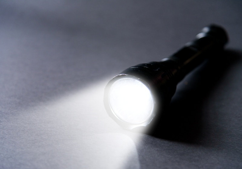 flashlight beam light on dark background | survival gift box