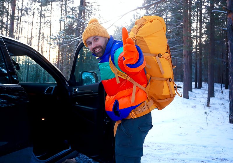 happy man winter forest waving hand | essentials needed for living in your car